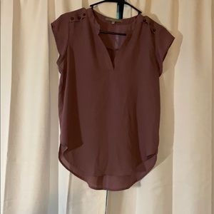 Cute blouse with button detail on sleeves.